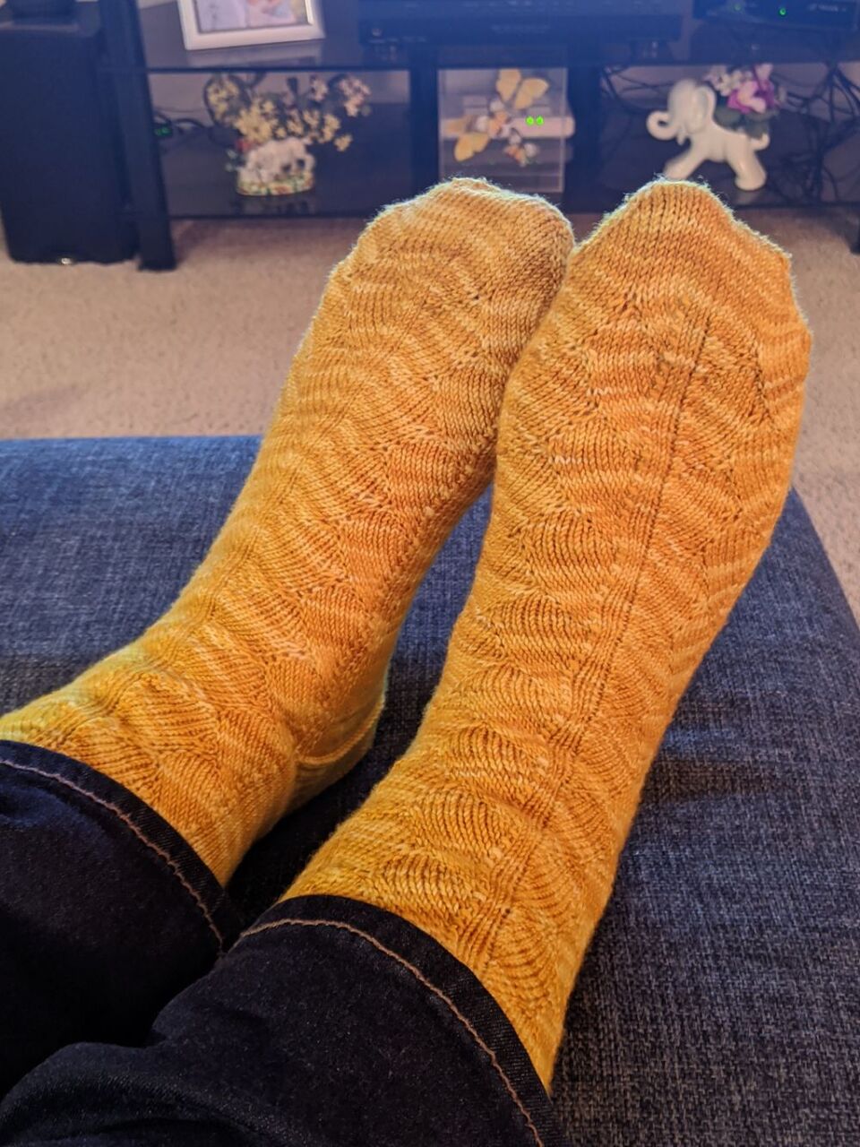 A picture of a pair of yellow socks with a scalloped design that I knit for Lenore.