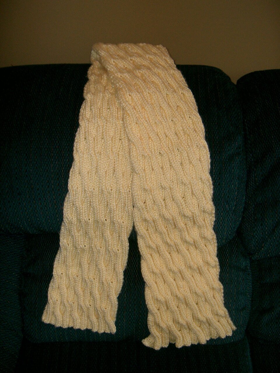 Photo of the completed scarf showing of the fun cable design.