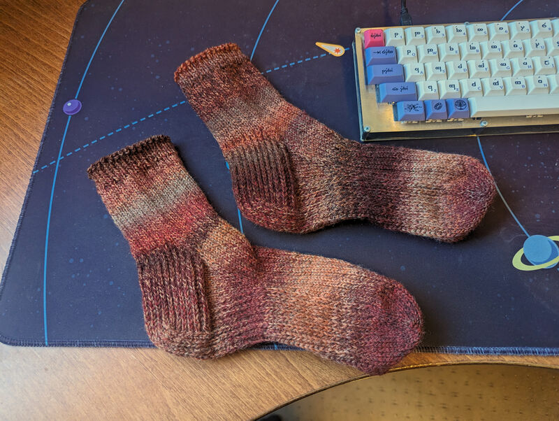 Image of the complete pair of socks lying side-by-side near my hand-wired keyboard.