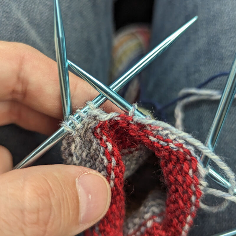 After knitting across the selvedge stitches and joining with the gusset, wrap and turn.