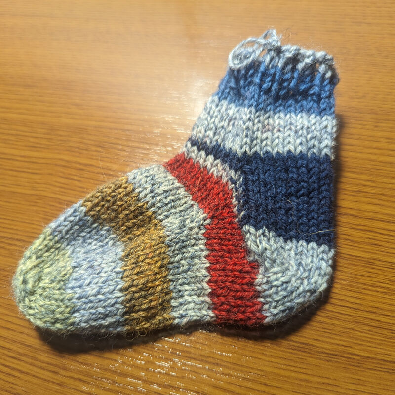 An image of the completed sock whose construction is illustrated in these lessons.