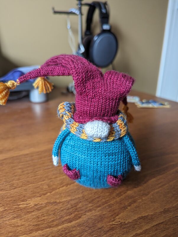 An example of a little knitted gnome that is the early bird prize in the raffle.