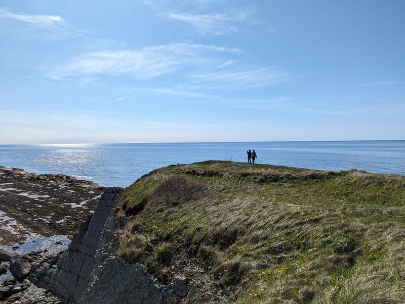 Wide shot of Green Point in Gros Morne with some friends off in the distance.